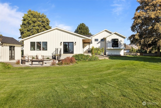 rear view of property with a lawn and a patio area