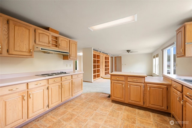 kitchen featuring ceiling fan, white gas stovetop, and kitchen peninsula