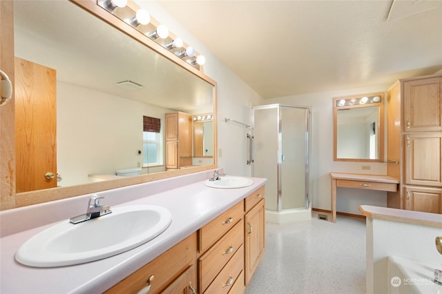 bathroom with vanity, toilet, and an enclosed shower