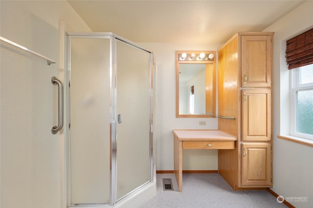 bathroom with a shower with door