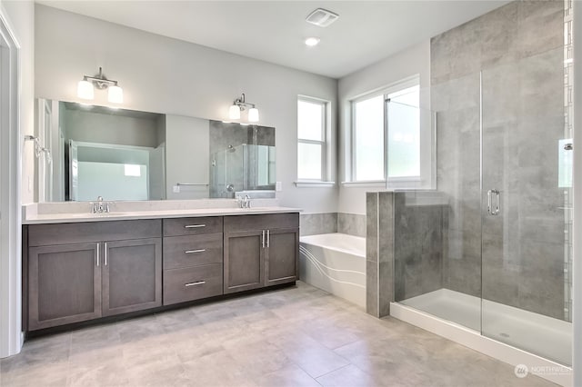 bathroom with vanity and independent shower and bath