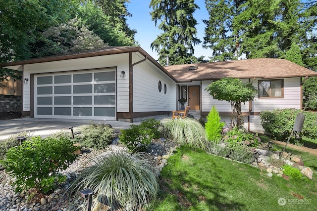 ranch-style house with a garage and a front lawn