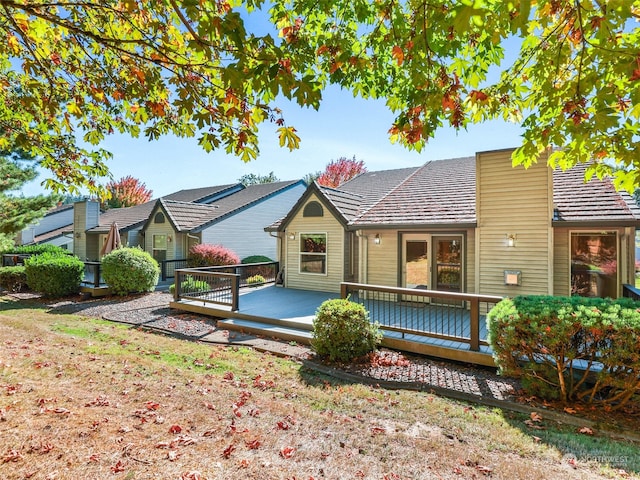 back of property with a wooden deck