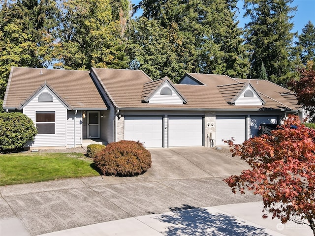 single story home with a front yard and a garage