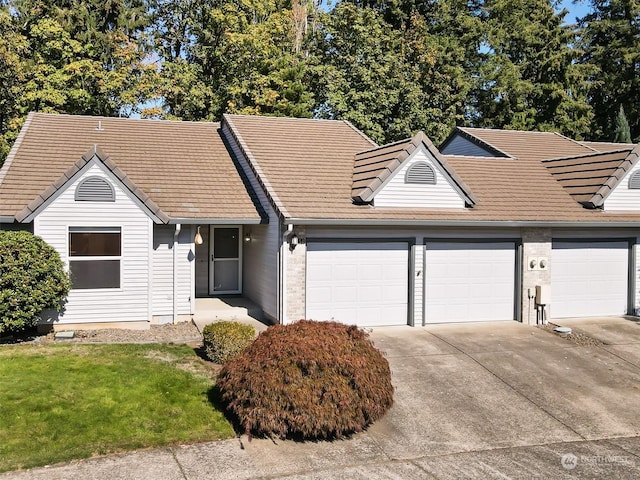 view of front of house with a garage and a front lawn