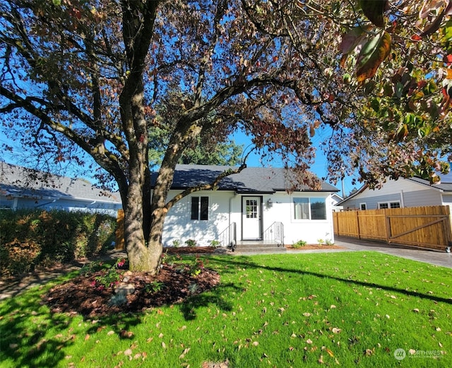 back of house with a lawn