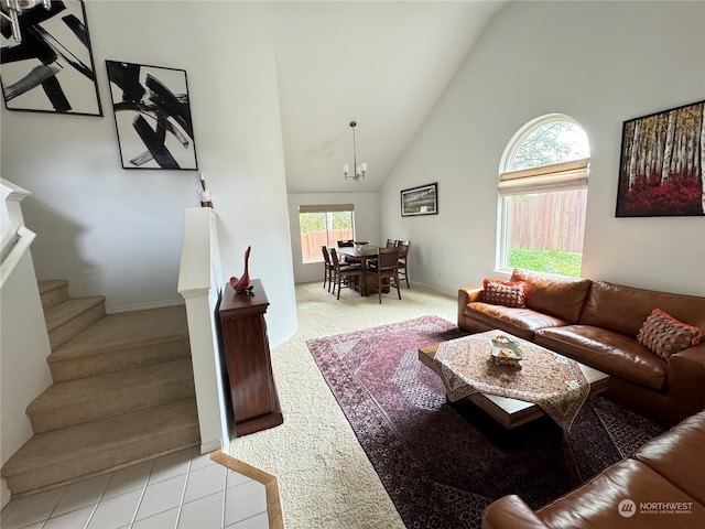 living room featuring high vaulted ceiling, an inviting chandelier, and light tile patterned floors