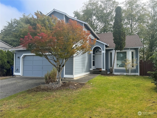 view of front of house featuring a front yard and a garage