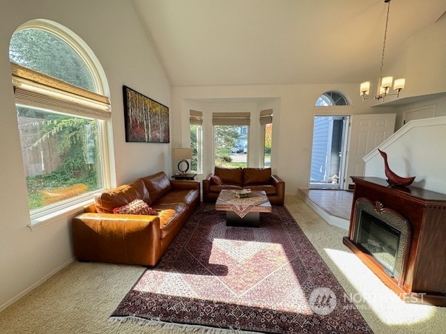 living room featuring lofted ceiling, a notable chandelier, and light carpet