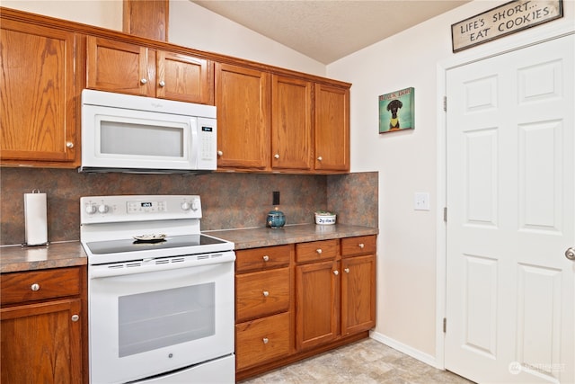 kitchen with decorative backsplash, white appliances, a textured ceiling, and vaulted ceiling