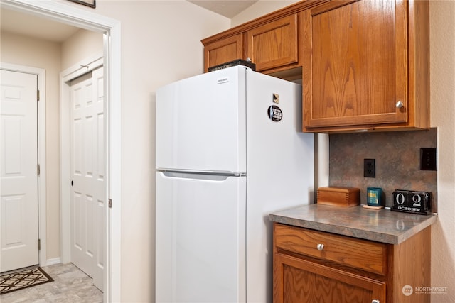 kitchen featuring tasteful backsplash and white fridge