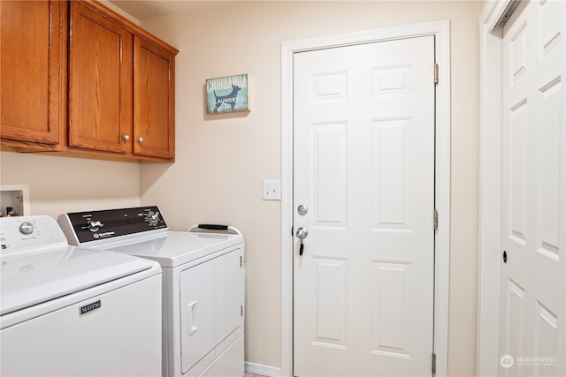 laundry area featuring cabinets and washer and dryer