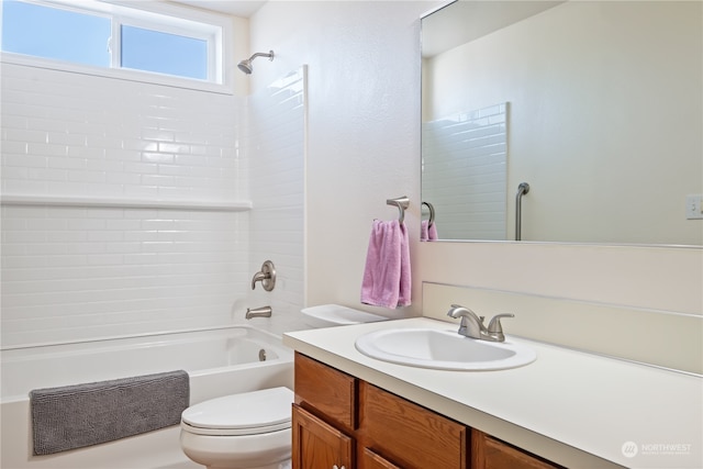 full bathroom with tiled shower / bath combo, vanity, and toilet