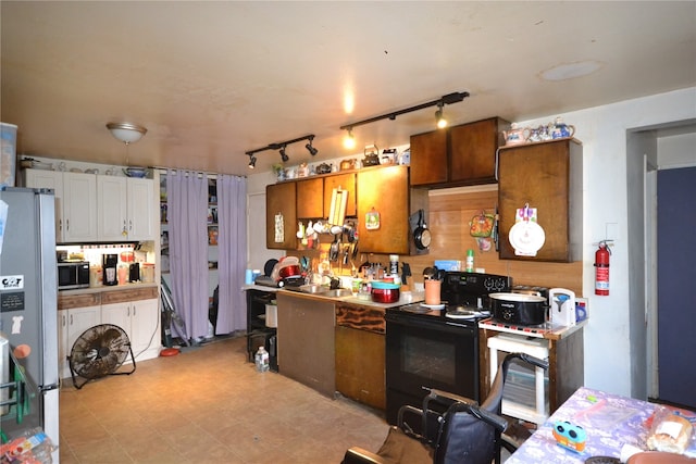 kitchen with black appliances and track lighting