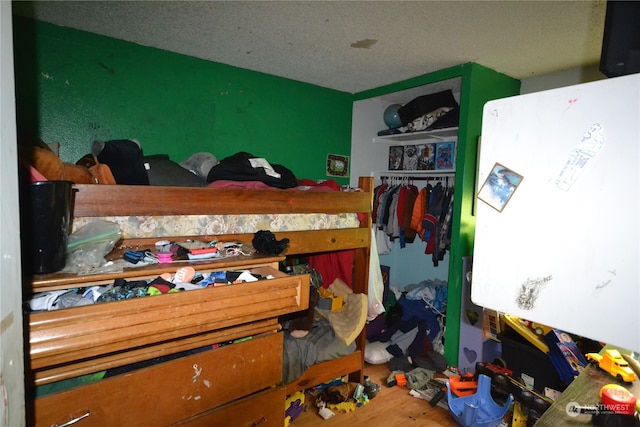 bedroom with a textured ceiling and a closet