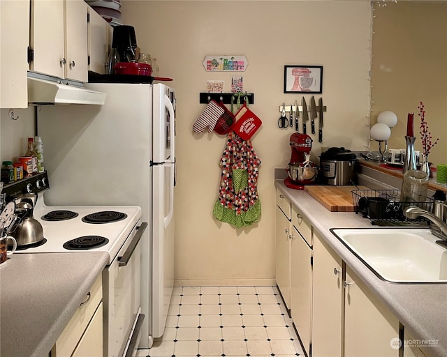 kitchen featuring white cabinetry, sink, and white range with electric cooktop