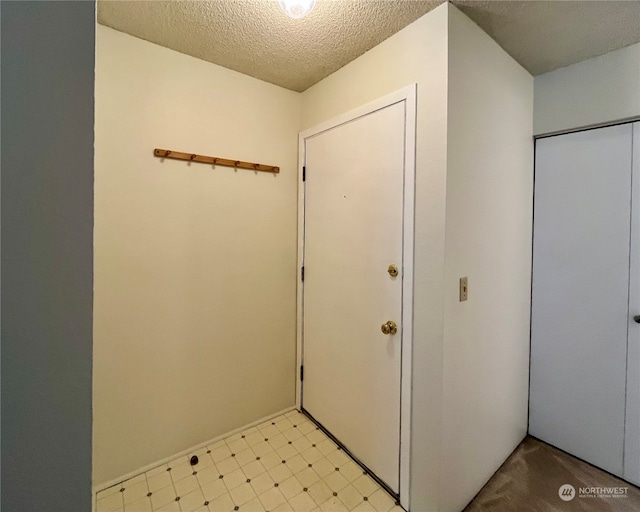 entryway featuring a textured ceiling