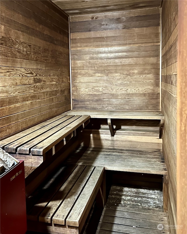 view of sauna / steam room featuring wooden walls