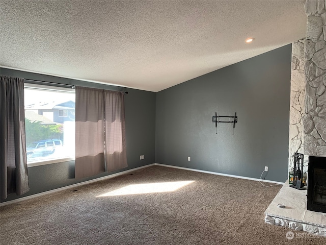 unfurnished living room featuring a textured ceiling, a fireplace, and carpet flooring