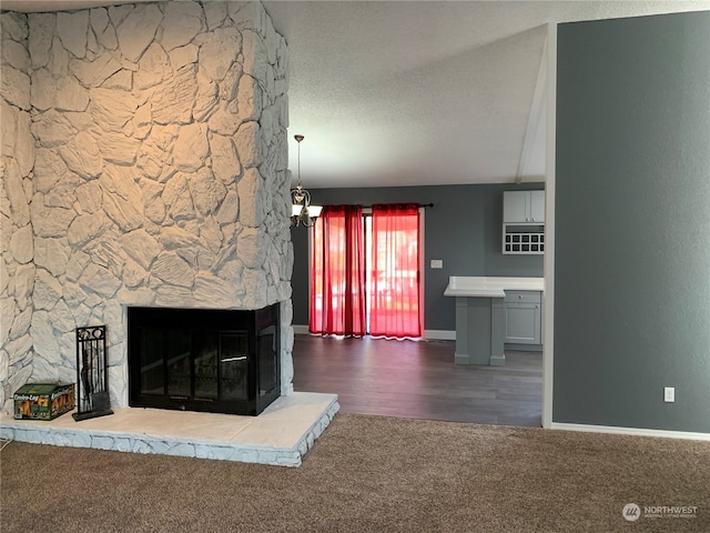 unfurnished living room with a textured ceiling, a fireplace, and dark wood-type flooring