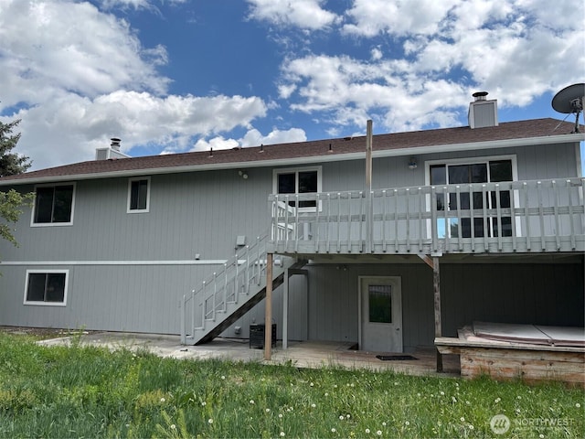 812 W Edgewater Ln, Moses Lake, WA 98837 - back of property with a wooden deck, a chimney, and stairway