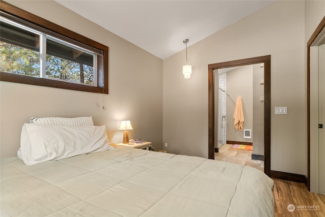 bedroom featuring vaulted ceiling and hardwood / wood-style floors