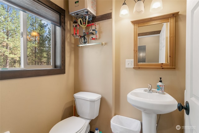 bathroom with water heater and toilet