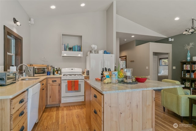 kitchen with sink, lofted ceiling, light hardwood / wood-style floors, and white appliances