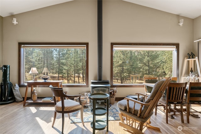 living area with light hardwood / wood-style flooring and high vaulted ceiling