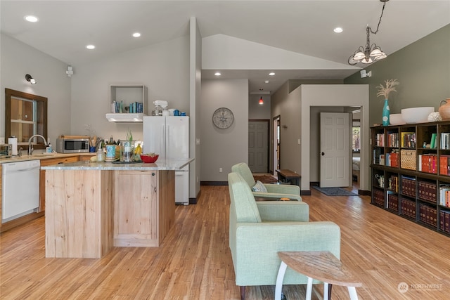 kitchen featuring light hardwood / wood-style flooring, hanging light fixtures, vaulted ceiling, and white appliances