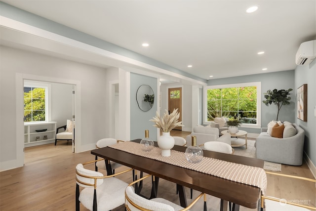 dining room featuring light hardwood / wood-style floors and a wall mounted AC