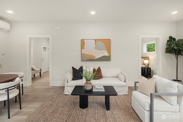 living room with light wood-type flooring and a wall mounted AC