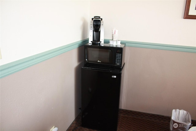 interior details with black microwave and fridge