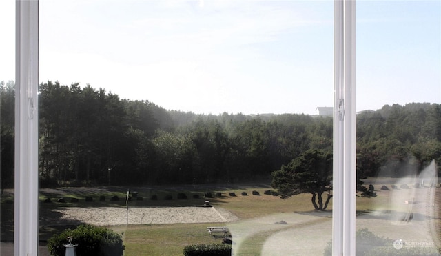 exterior space featuring a forest view
