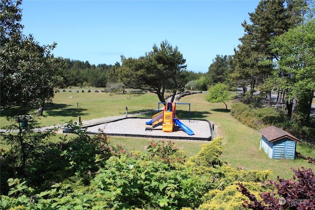 view of community featuring a lawn and playground community