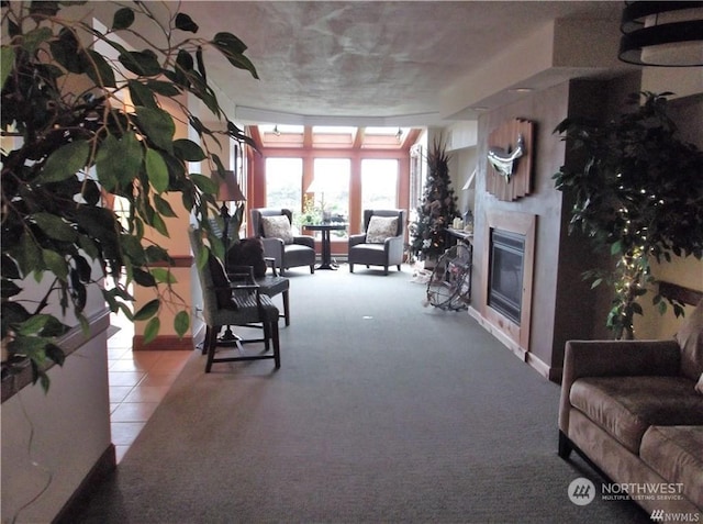 tiled living room with a glass covered fireplace