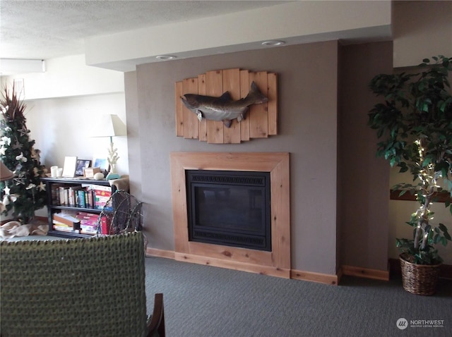 carpeted living room featuring baseboards and a glass covered fireplace