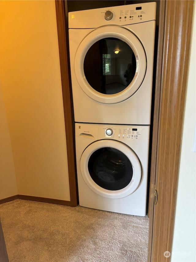 laundry room featuring carpet floors and stacked washer and clothes dryer