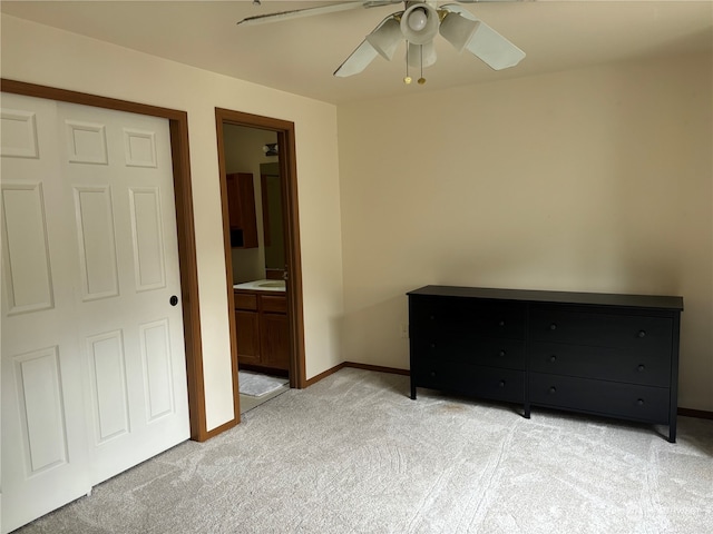 carpeted bedroom featuring ceiling fan, a closet, and connected bathroom