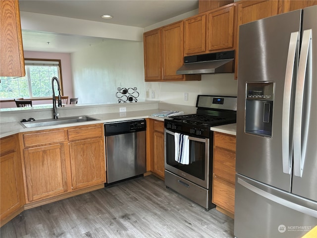 kitchen featuring appliances with stainless steel finishes, hardwood / wood-style floors, and sink