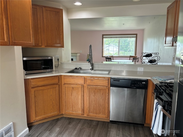 kitchen featuring appliances with stainless steel finishes, dark hardwood / wood-style floors, and sink