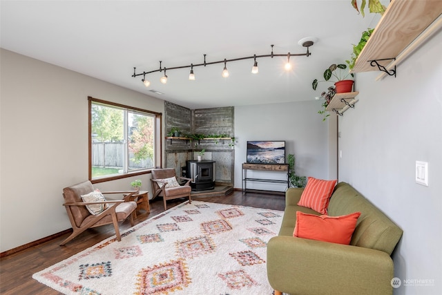 living area with dark wood-type flooring and a wood stove