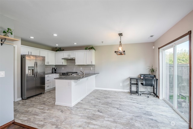 kitchen featuring appliances with stainless steel finishes, white cabinetry, kitchen peninsula, pendant lighting, and sink