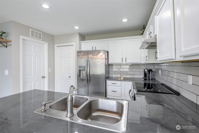 kitchen featuring black cooktop, sink, stainless steel fridge with ice dispenser, and white cabinetry