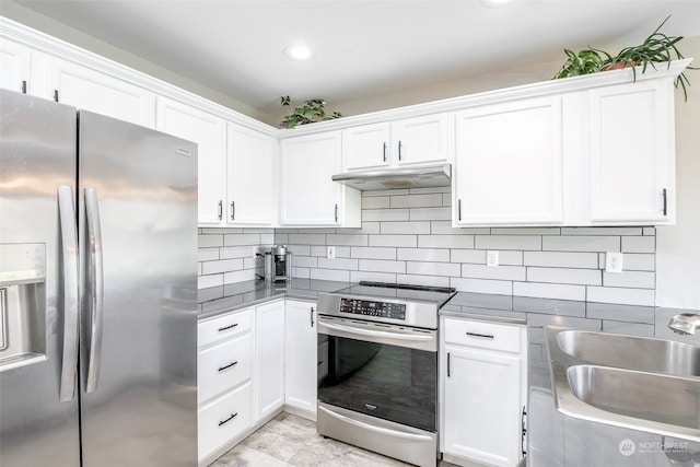 kitchen with white cabinets, stainless steel appliances, backsplash, and sink