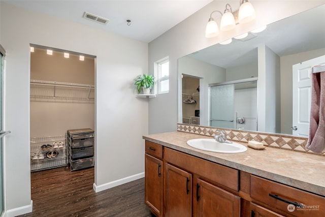 bathroom with vanity, hardwood / wood-style floors, and an enclosed shower