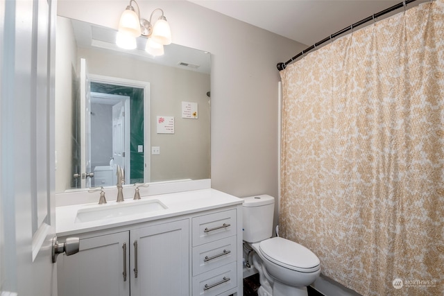 bathroom featuring walk in shower, vanity, and toilet