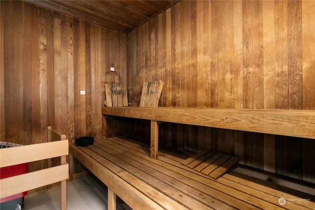 view of sauna with wooden walls and wooden ceiling