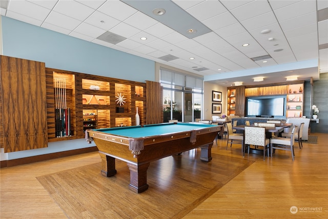 recreation room with a drop ceiling, light wood-type flooring, and billiards