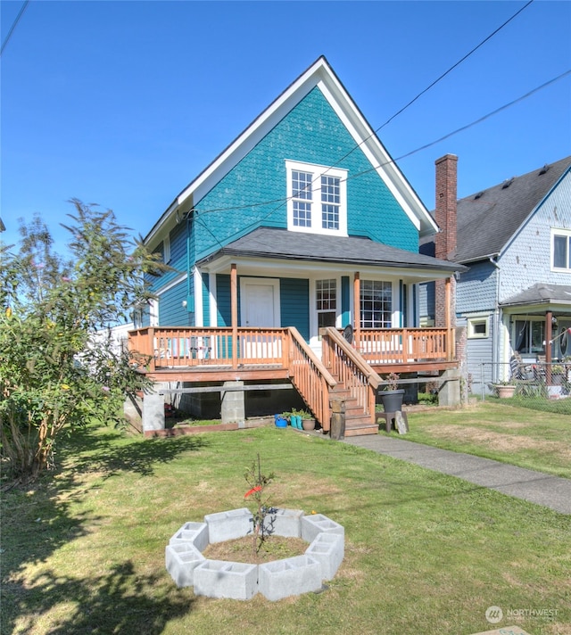 back of property with a lawn and a deck